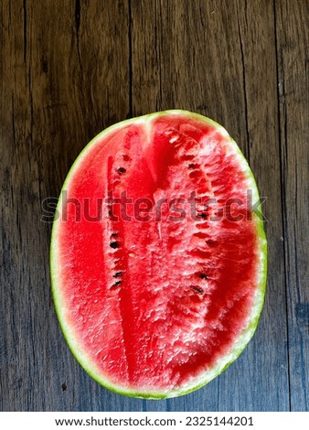 red watermelon on wooden table