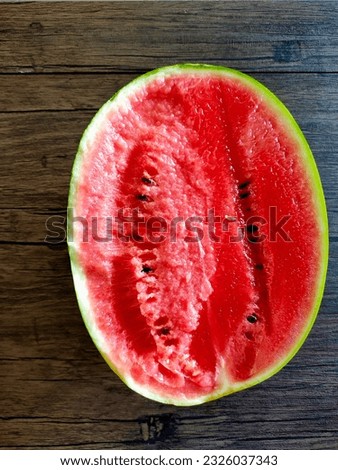red watermelon on wooden table