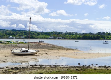 Red wharf bay, Anglesey, Wales. Beautiful landscape of sea and sand at low tide. Small pleasure boats on the sand flats. Blue sky - copy space.  - Powered by Shutterstock