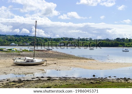 Red wharf bay, Anglesey, Wales. Beautiful landscape of sea and sand at low tide. Small pleasure boats on the sand flats. Blue sky - copy space. 