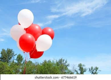 Red And White Balloons Against A Blue Sky.