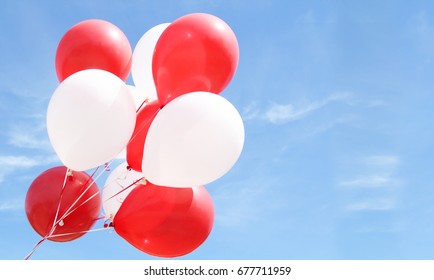 Red And White Balloons Against A Blue Sky. 