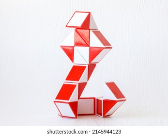 red and white bicolor magic snake Transformable twist puzzle in shape of cobra snake isolated on white background. it develops spatial thinking.