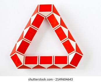 red and white bicolor magic snake Transformable twist puzzle in shape of triangle isolated on white background. it develops spatial thinking. version 1