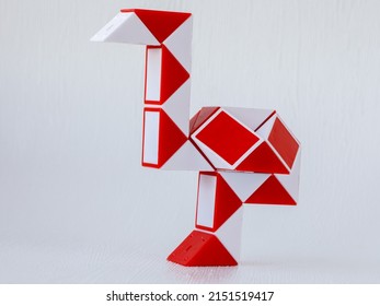 red and white bicolor magic snake Transformable twist puzzle in shape of ostrich isolated on white background. it develops spatial thinking.