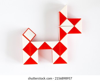 red and white bicolor magic snake Transformable twist puzzle in shape of dog isolated on white background. it develops spatial thinking. version 2