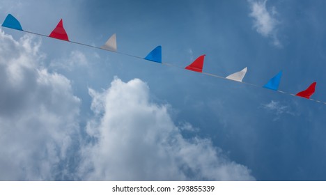 Red, White And Blue Bunting Against A Background Of A Summer Sky. 