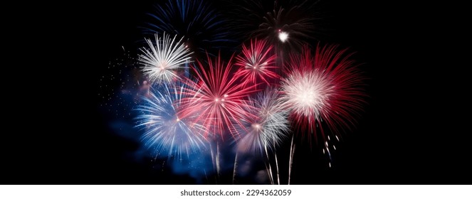 Red, white, and blue fireworks light up the night sky, patriotic celebration, New Years Eve or Independence Day. Shallow depth of field.  - Shutterstock ID 2294362059