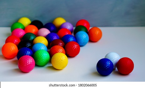 Red, White And Blue Golf Balls Highlighted, With Other Multicolored Golf Balls On The Side.                               