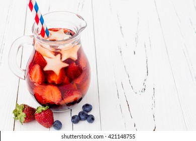 Red, White And Blue Lemonade Or Sangria. Patriotic Drink Cocktail With Strawberry, Blueberry And Apple For 4th Of July Party