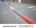 Red, white and blue painted kerbstones in Sandy Row, Belfast.  The painting of kerbstones is traditionally done by Protestants in Belfast to mark territory
