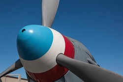 Red, White And Blue Painted Propeller Spinner On The Nose Of A Vintage WWII Aircraft.