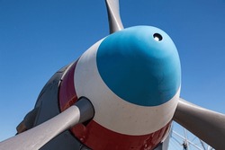 Red, White And Blue Painted Propeller Spinner On The Nose Of A Vintage WWII Aircraft.