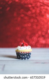 Red, White, And Blue Patriotic Cupcake With Red Sparkle Background