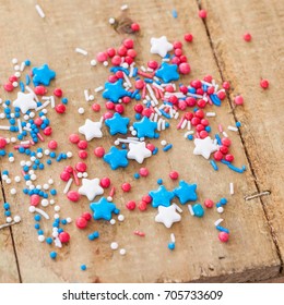 Red, White And Blue Sprinkles On Rustic Wooden Background