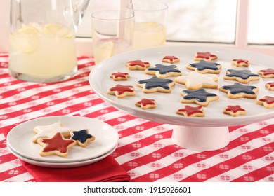 Red, White And Blue Star Cookies On Red And White Table Cloth