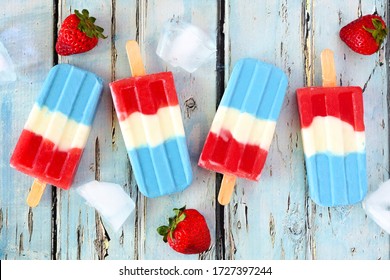 Red, White And Blue Summer Fruit Ice Pops. Top View On A Rustic Blue Wood Background.