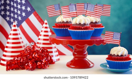 Red white and blue theme cupcakes with USA flags for Independance Day or USA theme party food. - Powered by Shutterstock