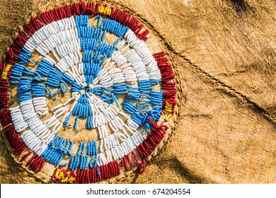 Red, White, Blue And Yellow Native American Beads Are Sewn In A Cross Pattern On A Buffalo Hide