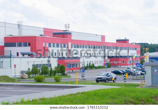 Red white building logistics center\
with cars in the parking. 26 July 2020 Minsk\
Belarus