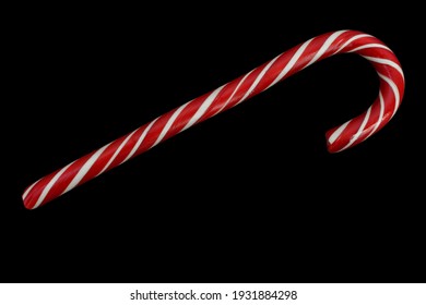 
red and white candy cane isolated on black background, top view - Powered by Shutterstock