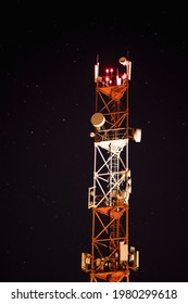 Red And White Cell Tower On The Background Of The Starry Sky. Mobile Communication Base Station In The Night