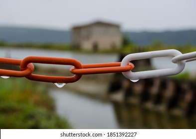 Red And White Chain With Rain Drops And Blurred Park In The Background - Shutterstock ID 1851392227