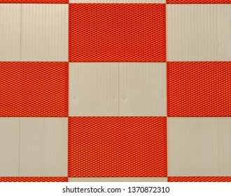 red and white checkered pattern on a metal wall, architecture background