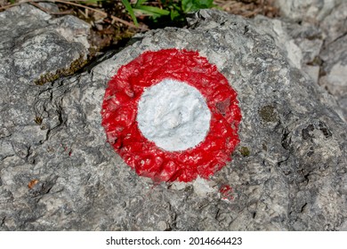 Red And White Circle Shaped Hiking Trail Sign On A Rock Wall. Tourist Sign. Symbol. Direction Sign.