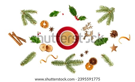 Red white coffee cup with Christmas  decor. Fir branches, holly berry, pine cone, dried apple and orange slices, cinnamon sticks, anis stars isolated on white background. Holiday winter decoration.