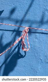 Red And White Cord In Blue Wall