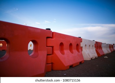 Red and white heavy duty plastic barrier, equipment barricading on roadside, preventing cars or another vehicles collision against into the concrete wall in Sydney city CBD, Australia   - Shutterstock ID 1080715136