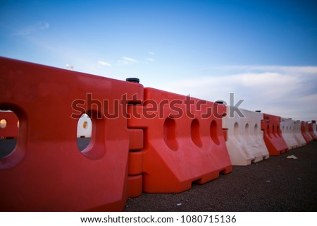 Red and white heavy duty plastic barrier, equipment barricading on roadside, preventing cars or another vehicles collision against into the concrete wall in Sydney city CBD, Australia  