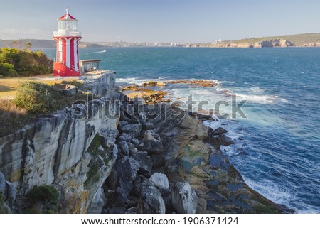 The red and white Hornby Lighthouse on a sunny summer day along the coastline in the Watsons Bay suburb of Sydney, NSW, Australia.