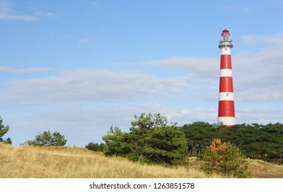Red and white lighthouse on island Ameland, Netherland.