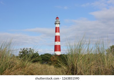 Red and white lighthouse on island Ameland, Netherland.
