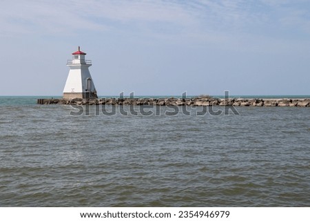 Red and white lighthouse on a pier