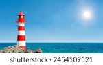 Red and white lighthouse on the seashore