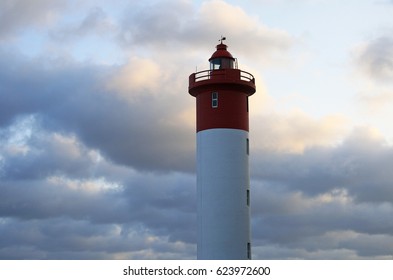 RED AND WHITE LIGHTHOUSE WITH TINTED CLOUDS - Shutterstock ID 623972600