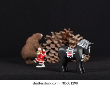 Red And White Mini Figure Isolated On Black. Christmas Decoration, Pine Cones, Horse, Bear On Black Background. Closeup