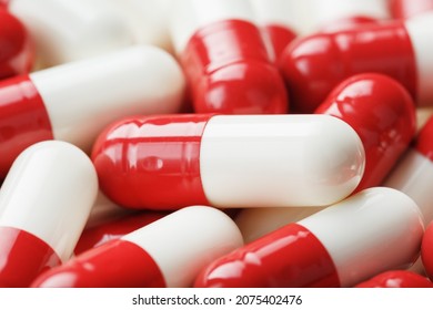 Red and white pills as a background in full screen. top view. Medicinal preparations - Shutterstock ID 2075402476