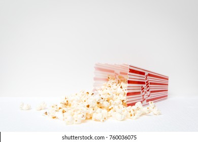 Red And White Popcorn Container With Spilled Popcorn On Ground