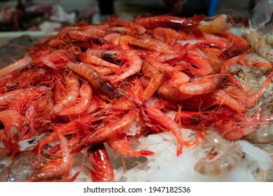 A lot of red and white prawns in a food market