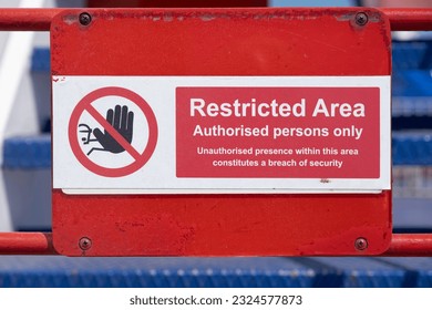 Red and white restricted area sign, authorized persons only, with hand icon, on the deck of a ferry - Shutterstock ID 2324577873