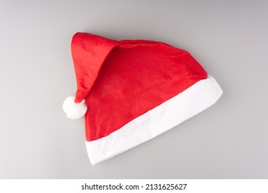 Red and white Santa Claus hat on a gray background. - Powered by Shutterstock