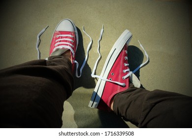 Red And White Sneakers/trainers With Untied Shoe Laces