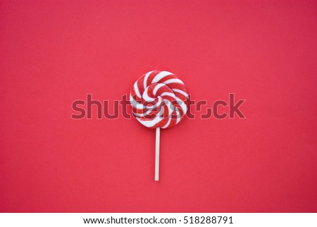 a red and white spiral lollipop