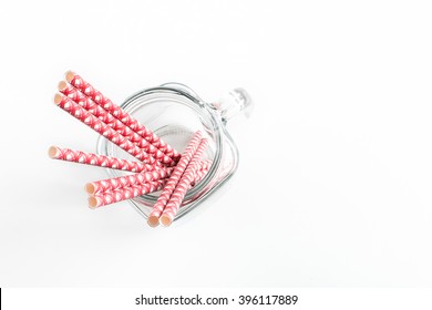 Red And White Straws In A Clear Jar Isolated On A White Background With Empty Space For Writing Your Own Message