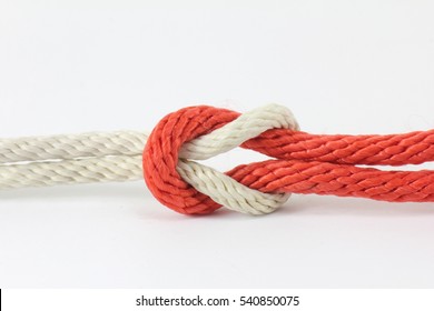 Red and white string knotted on a white background.

