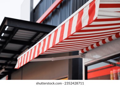 red and white striped awning. canvas roof of the shop.